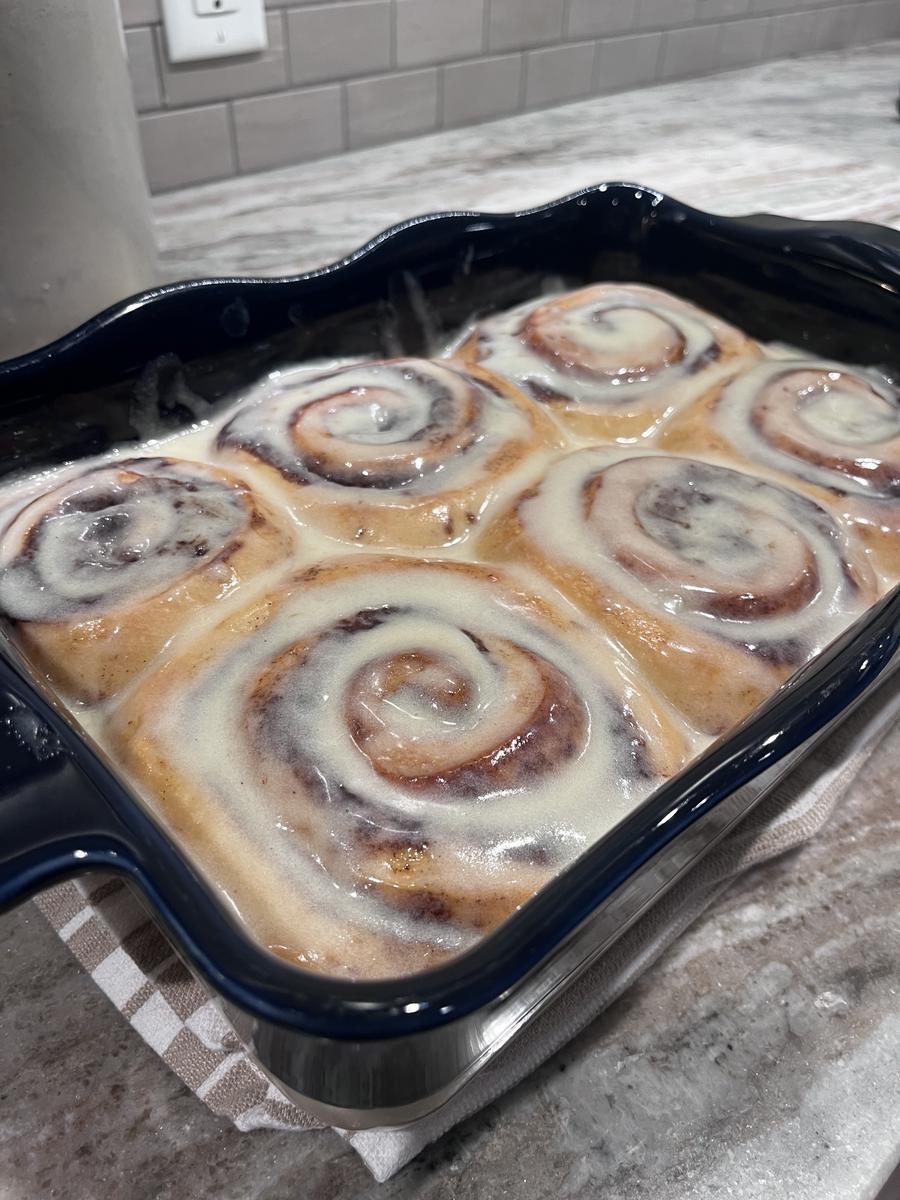 Fresh cinnamon rolls in blue baking dish